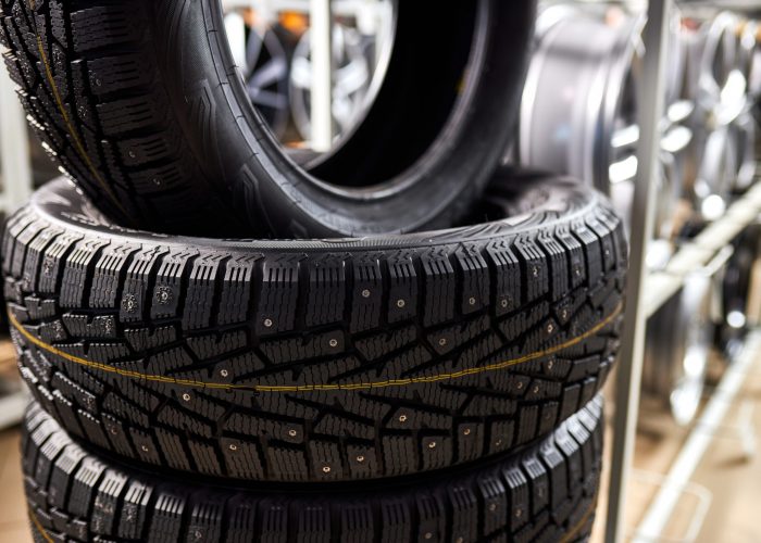 close-up-new-tires-auto-repair-service-center-brand-new-winter-tires-with-modern-tread-isolated-selective-focus-scaled.jpg