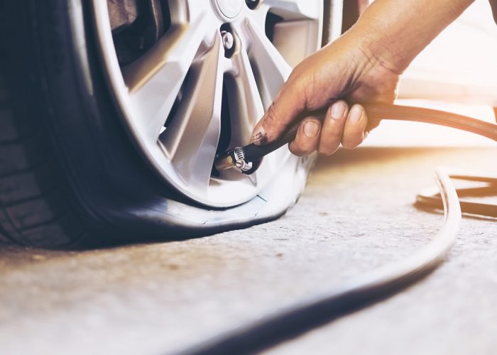 technician-is-repairing-car-flat-tire-scaled.jpg